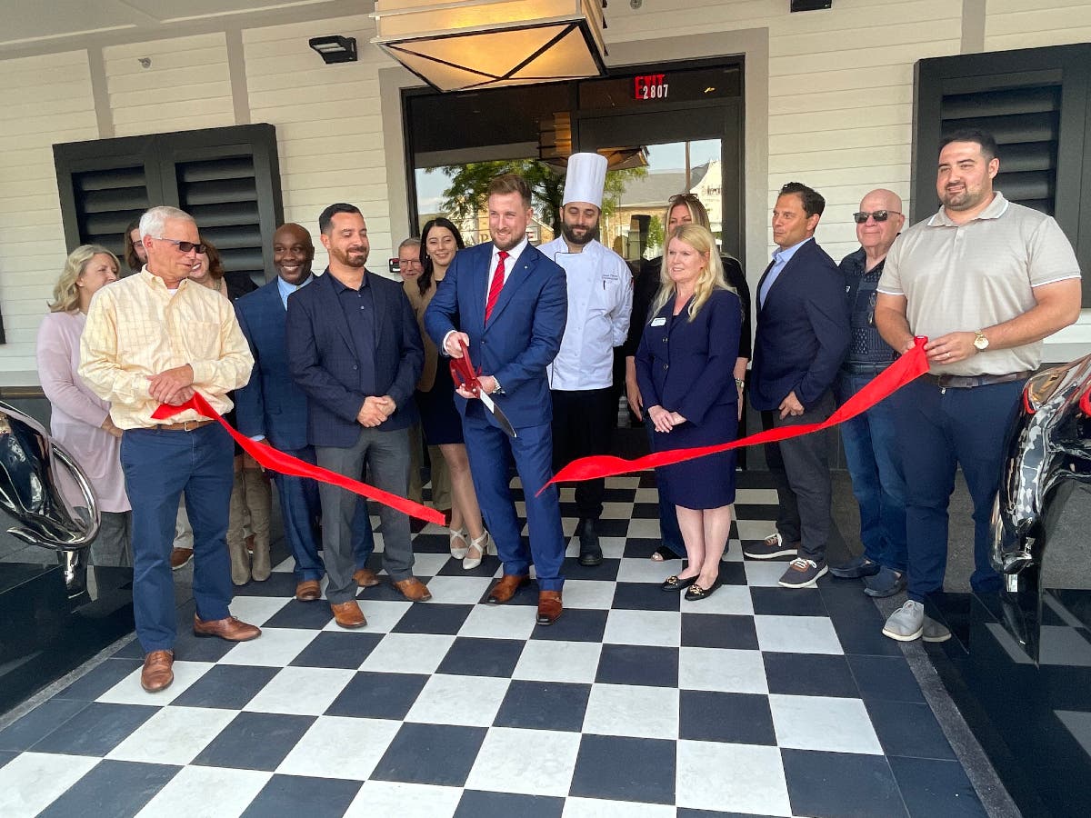 Managing partner Michael Callahan cuts the ribbon on the new restaurant.