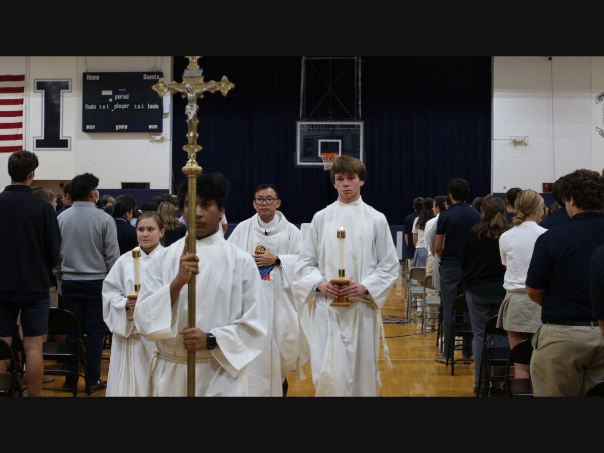 Immaculate’s Chaplain Father Philip Phan (center) celebrates Mass with Seamus Reidy ‘23 (far right) and other members of the school's Campus Ministry Program.