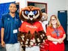 FAU ACI Class of 2024 graduates Michael Johnson and Whitney Wiley with FAU’s mascot Owlsley