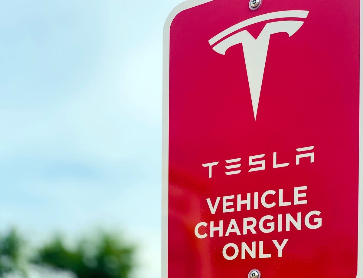 Planned for the Tesla Supercharger station is over two dozen electric-vehicle charging stalls, two outdoor movie screens and a restaurant with rooftop seating, according to city documents. 