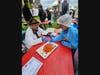 Gaurav Gupta, an associate professor in the Department of Neurosurgery at Robert Wood Johnson Medical School, leads Morgan Nathan, 7, through a demonstration of Jello-brain surgery.
