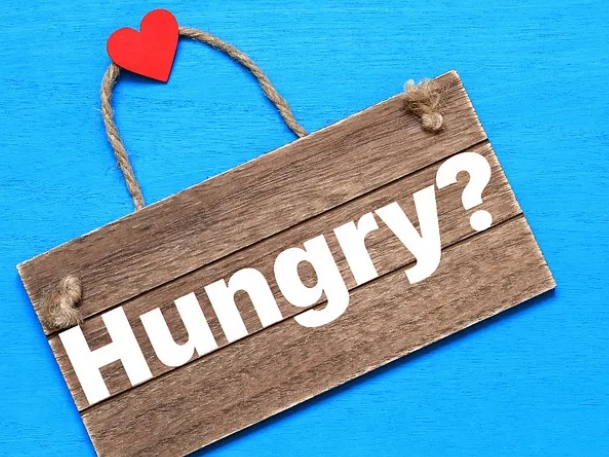 wall hanging plaque with the word, "Hungry?" written on it. Heart decoration is glued to the top of the wall hanging. 