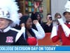Old Bridge High School senior Lola Adeleye (center) exults with members of the Rutgers Marching Scarlet Knights after announcing on the Today Show that she will attend Rutgers in the fall.