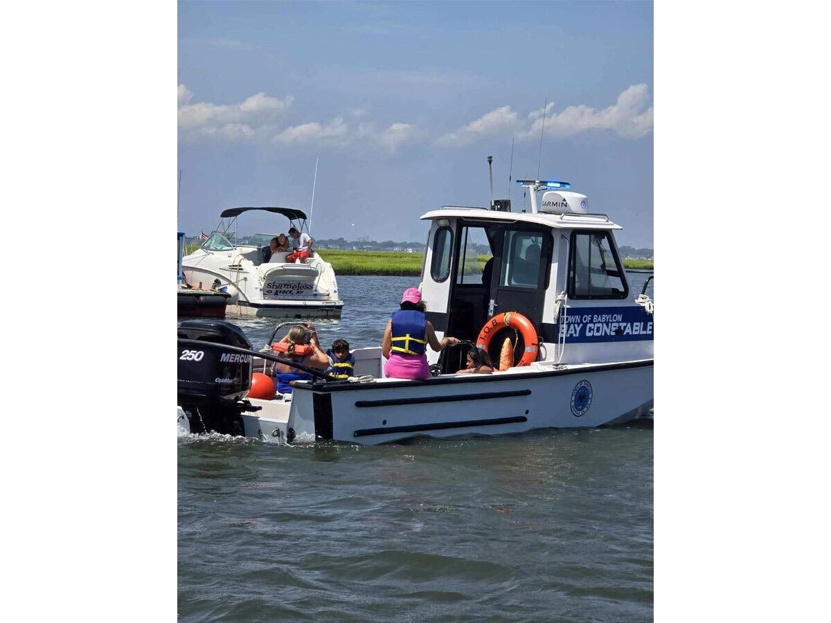 Town of Babylon bay constables Bill Ross and Charlie Fico rescued a family in distress aboard a 26' Mazum taking in water by the Amityville Cut area. 