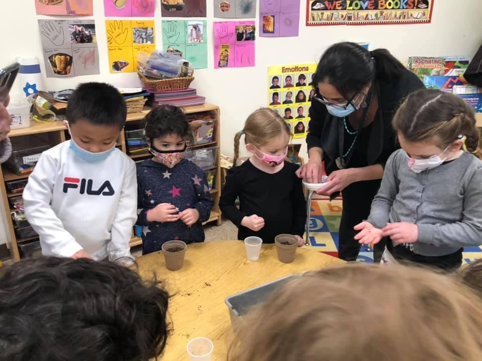 Shown planting their seeds are Early School students with teacher Nisha Khanna. 