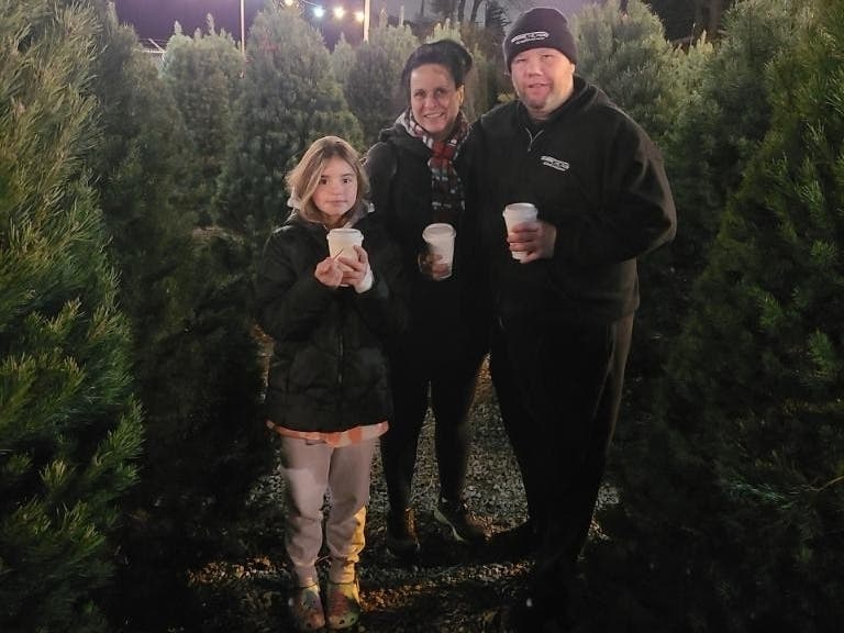 Robin Flannery (center) with her husband Bernie Coffey and granddaughter Reece. 