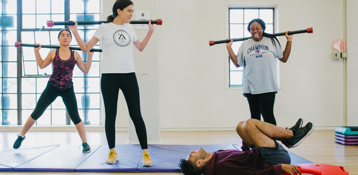 Students laughing during a fitness class