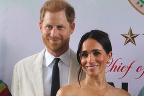 Britain's Prince Harry, Duke of Sussex, and Britain's Meghan, Duchess of Sussex, pose for a photo as they attend the program held in the Armed Forces Complex in Abuja, Nigeria on May 11, 2024.