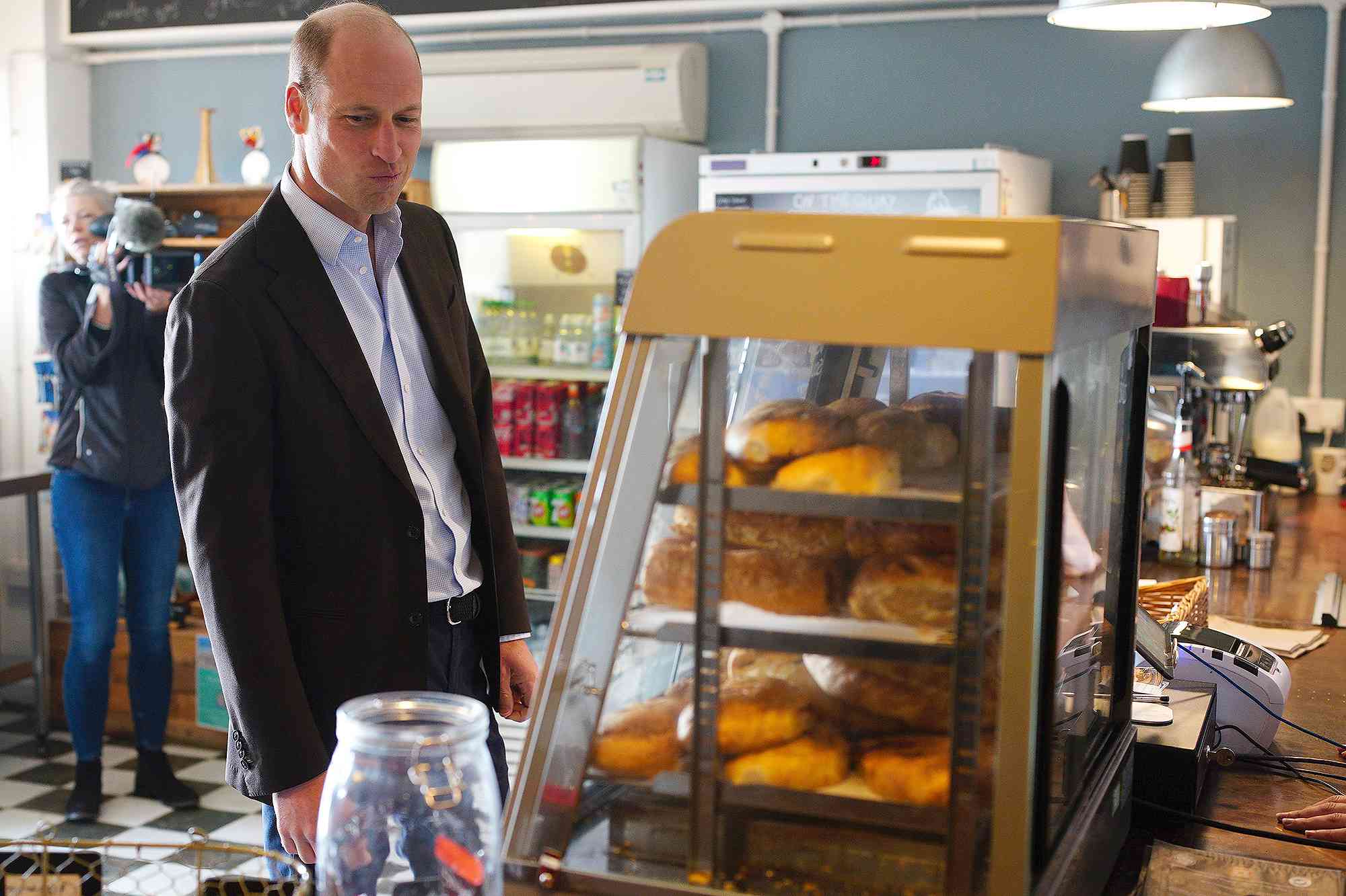 ISLES OF SCILLY, ENGLAND - MAY 10: Prince William, Prince of Wales, known as the Duke of Cornwall when in Cornwall, reacts as he speaks to some people in a store as he visits St. Mary's Harbour, the maritime gateway to the Isles of Scilly, to meet representatives from local businesses operating in the area on May 10, 2024 in Isles of Scilly, England. 