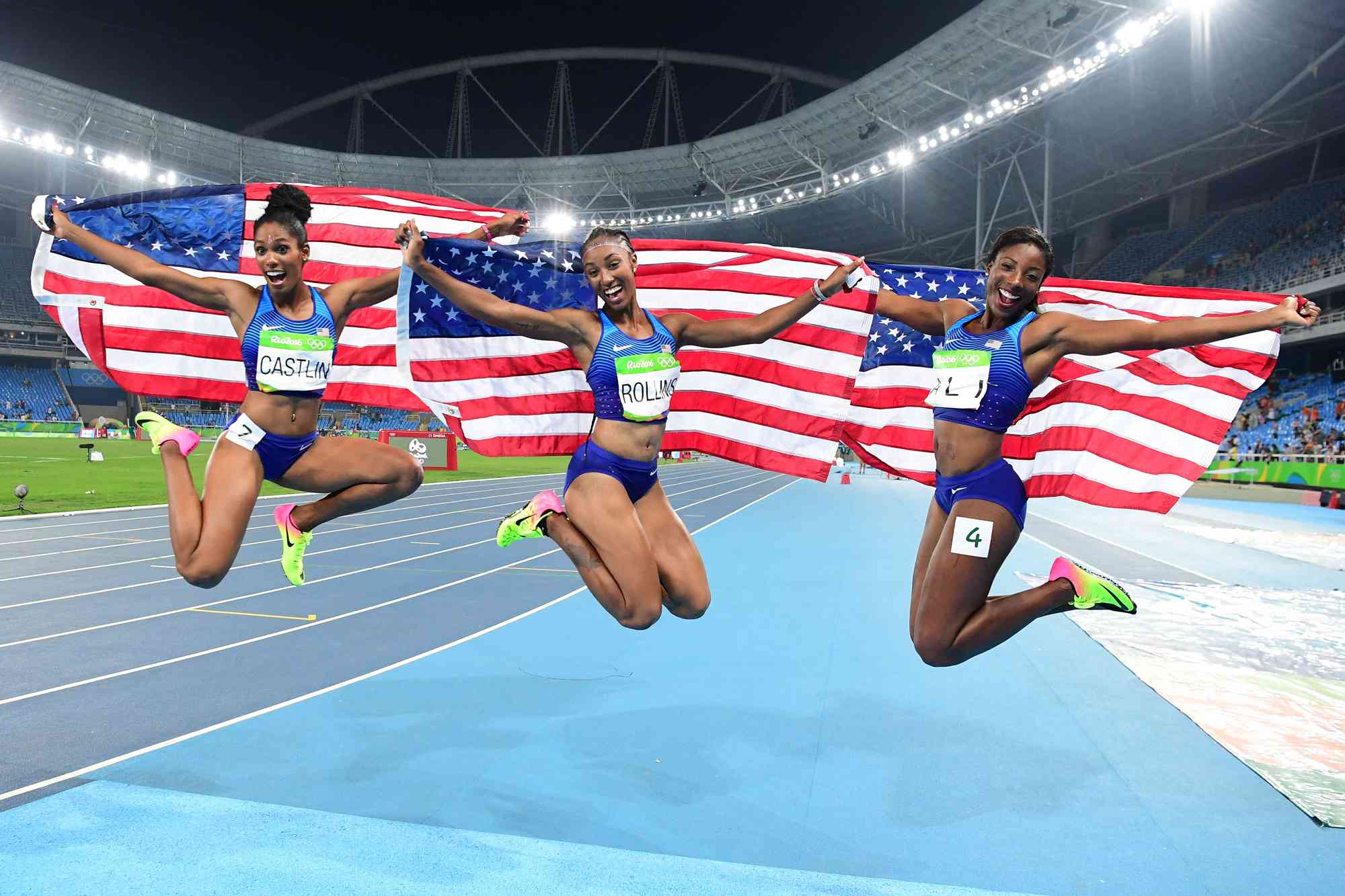 Bronze medallist USA's Kristi Castlin, gold medallist USA's Brianna Rollins and silver medallist USA's Nia Ali celebrate after the Women's 100m Hurdles Final during the athletics event at the Rio 2016 Olympic Games at the Olympic Stadium in Rio de Janeiro on August 17, 2016. 