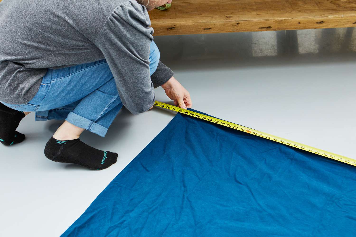 Person measuring the L.L. Bean Ultrasoft Comfort Flannel Comforter Cover using measuring tape