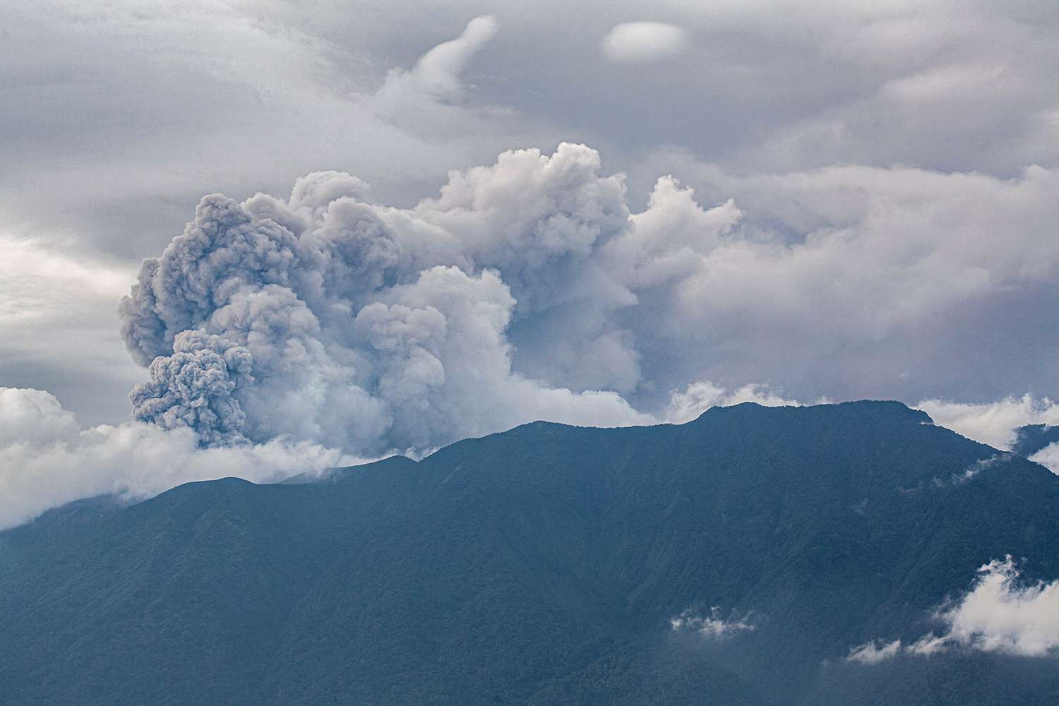 Volcanic ash spews from Mount Marapi during an eruption as seen from Tanah Datar in West Sumatra