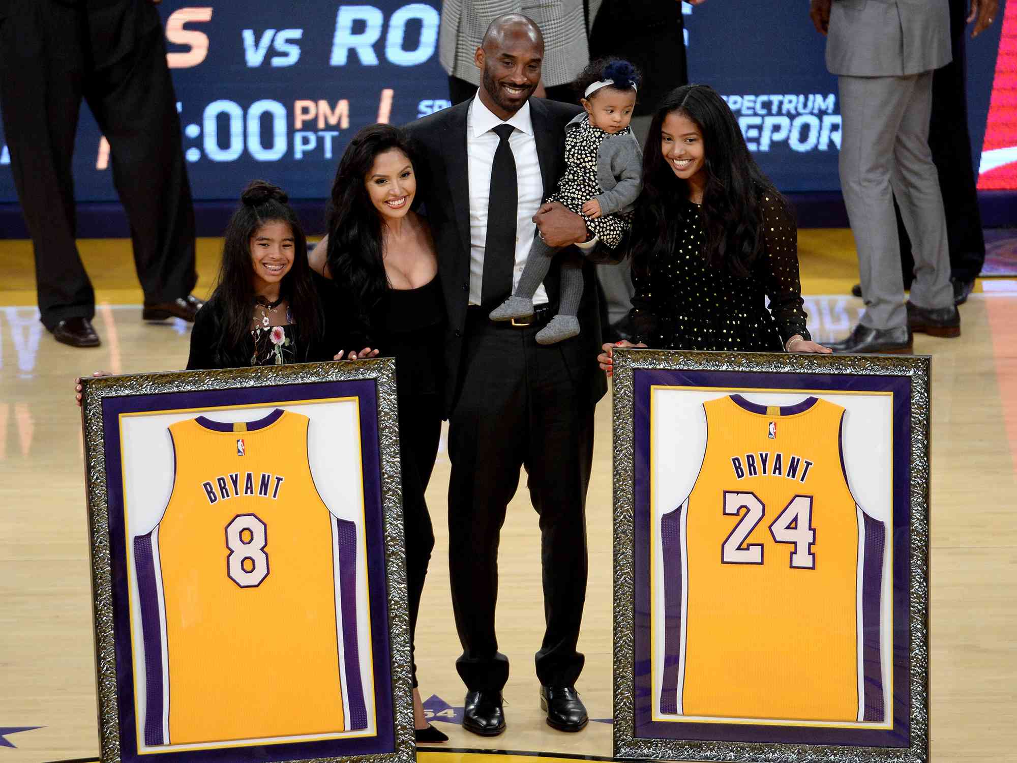 Kobe Bryant poses with his family at halftime after both his #8 and #24 Los Angeles Lakers jerseys are retired at Staples Center on December 18, 2017 in Los Angeles, California