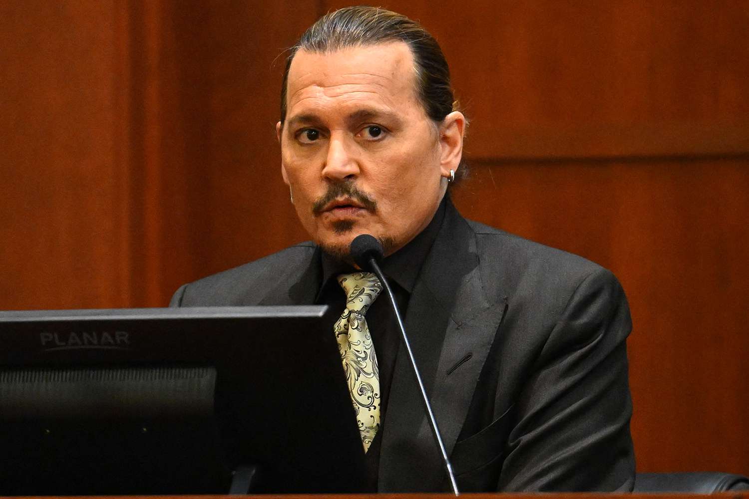 US actor Johnny Depp testifies during his defamation trial in the Fairfax County Circuit Courthouse in Fairfax, Virginia, on April 19, 2022. - Depp is suing ex-wife Amber Heard for libel after she wrote an op-ed piece in The Washington Post in 2018 referring to herself as a public figure representing domestic abuse.