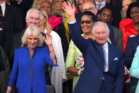 Britain's King Charles III (R) and Britain's Queen Camilla wave as they arrive to attend the Coronation Concert at Windsor Castle in Windsor, west of London on May 7, 2023. - For the first time ever, the East Terrace of Windsor Castle will host a spectacular live concert that will also be seen in over 100 countries around the world