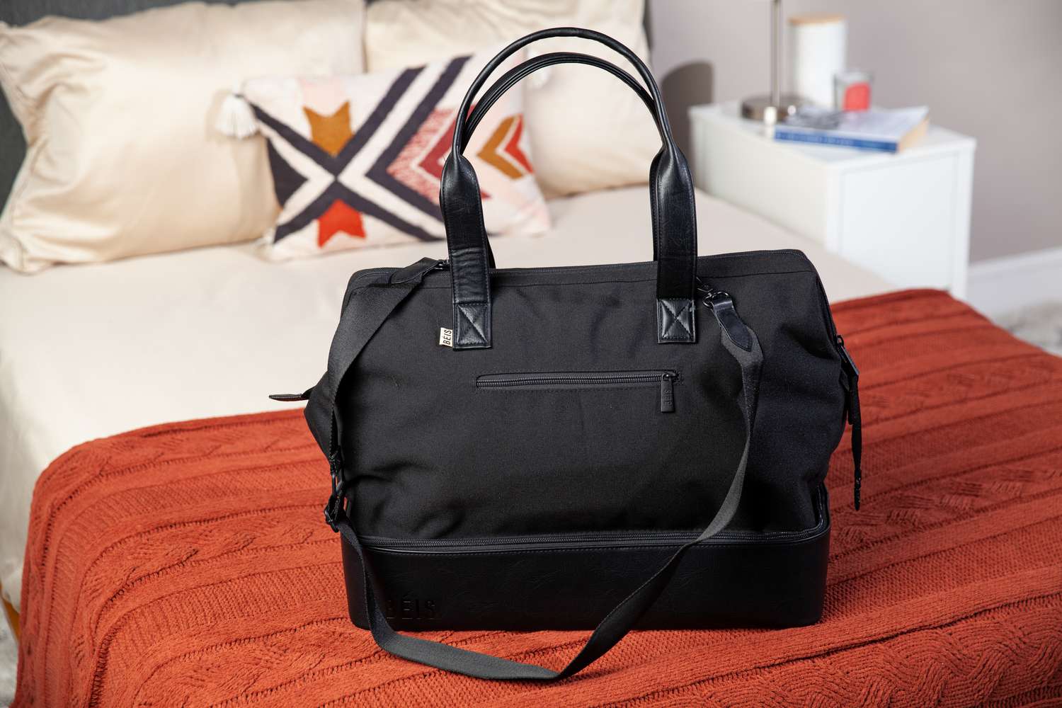 Béis The Weekender Travel Bag sitting on a bed