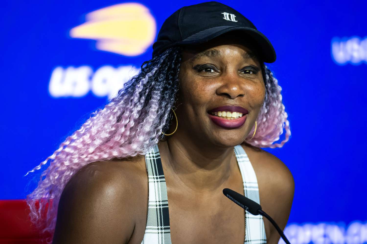 Venus Williams of the United States talks to the media after losing to Greet Minnen of Belgium in the first round on Day 2 of the US Open 