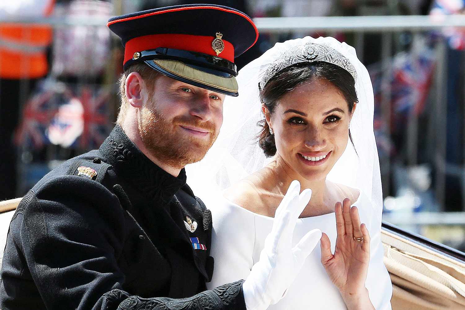 Britain's Prince Harry, Duke of Sussex and his wife Meghan, Duchess of Sussex wave from the Ascot Landau Carriage during their carriage procession on the Long Walk as they head back towards Windsor Castle in Windsor, on May 19, 2018 after their wedding ceremony.