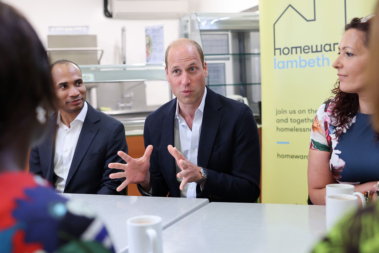 Prince William, Prince of Wales speaks with members during his visit to Mosaic Clubhouse on June 26, 2023 in London