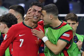 Cristiano Ronaldo of Portugal in tears is comforted by teammate Diogo Dalot during the break before extra time during the UEFA EURO 2024 round of 16 match between Portugal and Slovenia at Frankfurt Arena on July 1, 2024 in Frankfurt am Main, Germany. 