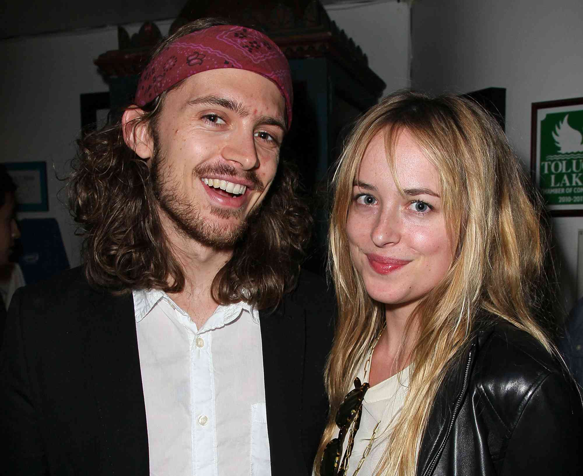 Alexander Bauer (L) and actress Dakota Johnson attend the opening night of "No Way Around But Through" 