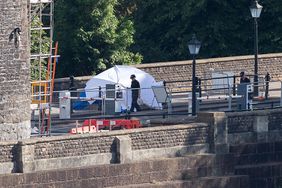 Police are seen by a forensics tent in relation to the discovery of human body parts found in two suitcases on the North Somerset side of the Clifton Suspension Bridge.