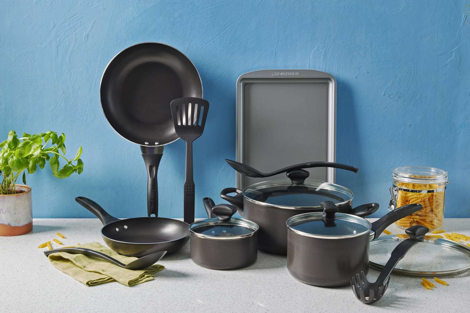 The Farberware Dishwasher Safe Nonstick 15 Piece Cookware Pots and Pans Set displayed on a white surface 