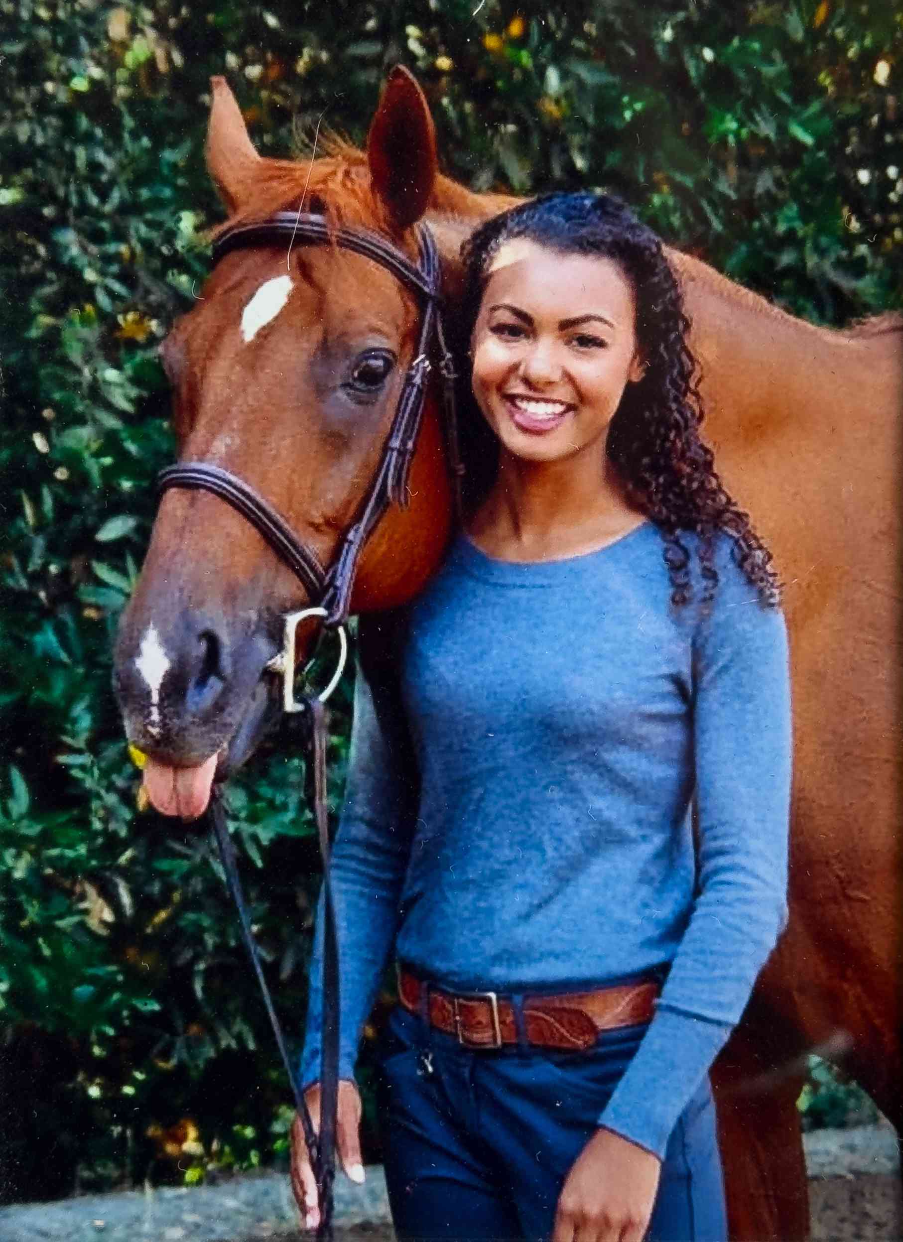 Malika Andrews with her horse, Dante, in 2014.