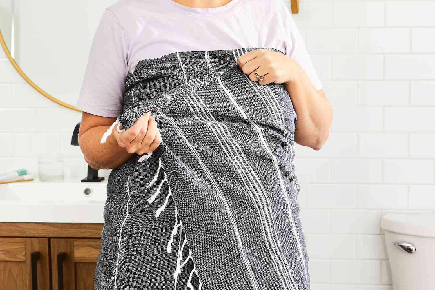 Person wrapping Cacala 100% Organic Cotton Pestemal Turkish Bath Towel around their body