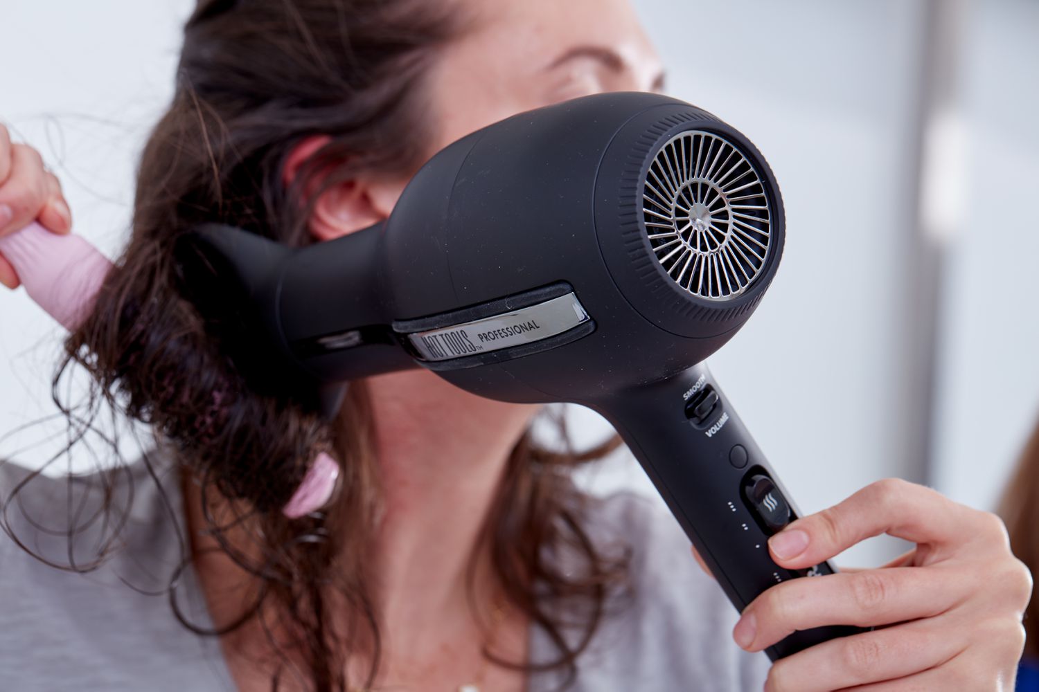 Person using the Hot Tools Pro Artist Black Gold Ionic Hair Dryer