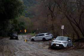 Vehicles along a mud-covered road during a storm in Malibu, California, US, on Monday, Feb. 5, 2024. Los Angeles and the wealthy enclaves of Montecito and Malibu