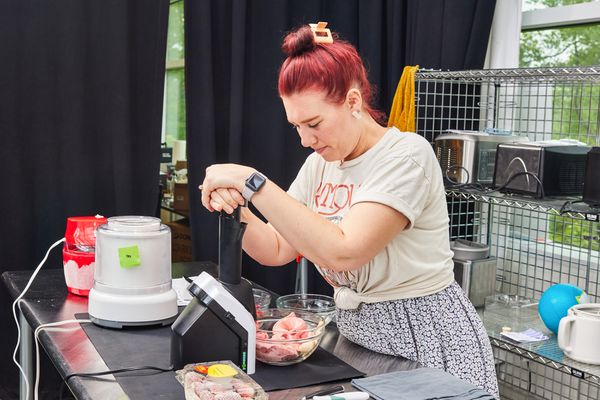 Person pushing the finished soft serve out of the Yonanas Classic Soft-Serve Dessert Maker into a bowl