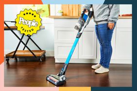 Person vacuuming a kitchen with the Black+Decker Powerseries Extreme Cordless Stick Vacuum