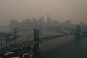 The Downtown Manhattan skyline stands shrouded in a reddish haze as a result of Canadian wildfires on June 06, 2023 in New York City