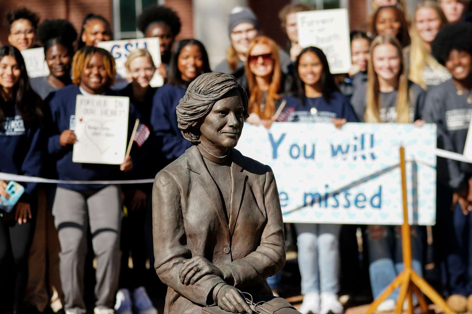 Students watch as family members participate in a wreath laying ceremony to honor former first lady Rosalynn Carter at the Rosalynn Carter Health & Human Services complex on the campus of Georgia Southwestern State University, in Americus, Georgia, on November 27, 2023.