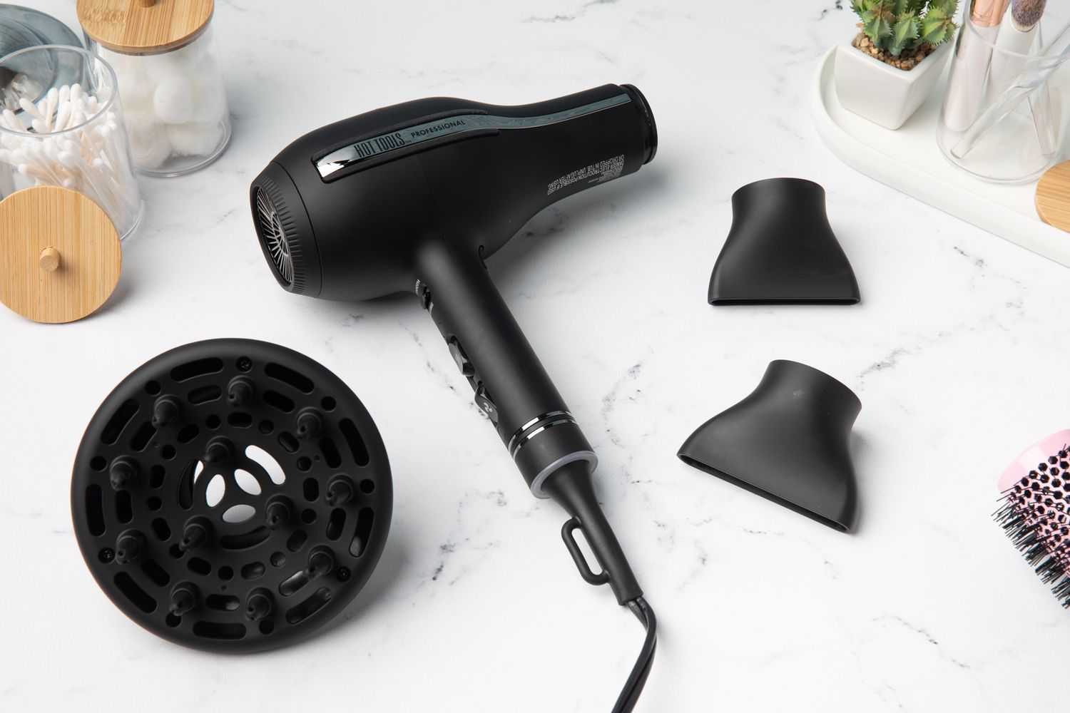 Hot Tools Pro Artist Black Gold 2000 Watt Ionic Hair Dryer with attachments on counter