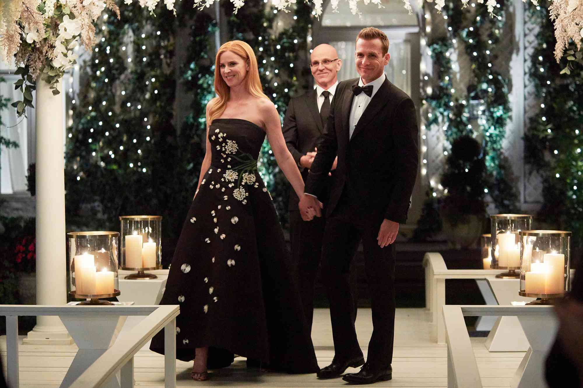 Sarah Rafferty as Donna Paulsen, Ray Proscia as Dr. Stan Lipschitz, and Gabriel Macht as Harvey Specter on 'Suits'.