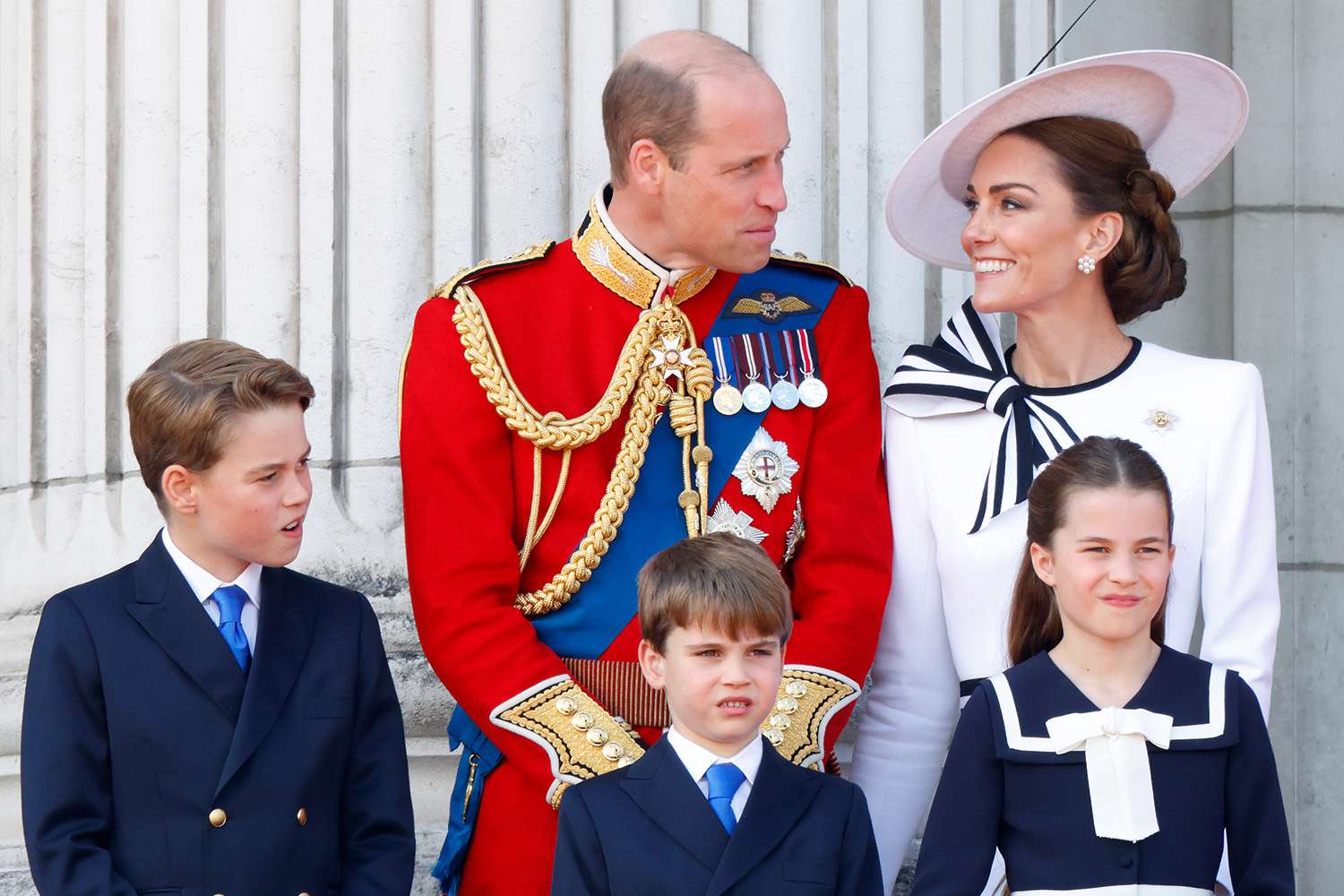 Prince George of Wales, Prince William, Prince of Wales (Colonel of the Welsh Guards), Prince Louis of Wales, Princess Charlotte of Wales and Catherine, Princess of Wales watch an RAF flypast from the balcony of Buckingham Palace 