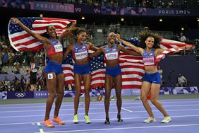 Gold medallists (from L) US' Alexis Holmes, US' Gabrielle Thomas, little and US' Sydney Mclaughlin-Levrone celebrate winning the women's 4x400m relay final of the athletics event at the Paris 2024 Olympic Games at Stade de France in Saint-Denis, north of Paris, on August 10, 2024.