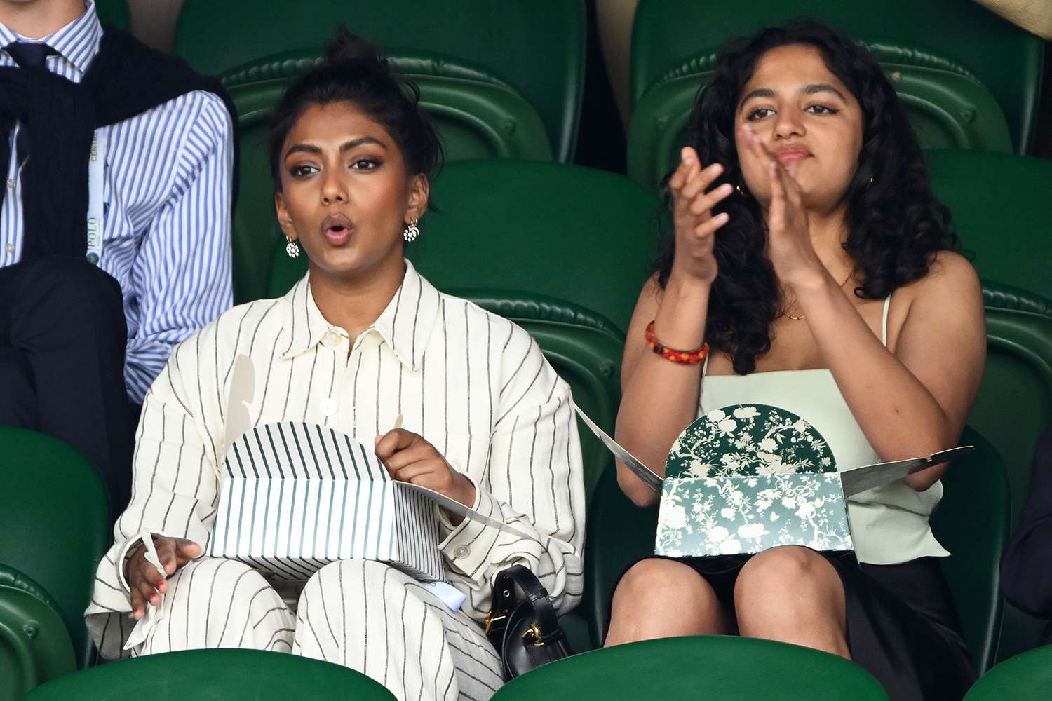 Charithra Chandran (L) reacts as she attends day ten of the Wimbledon Tennis Championships at the All England Lawn Tennis and Croquet Club on July 12, 2023 in London, England. 