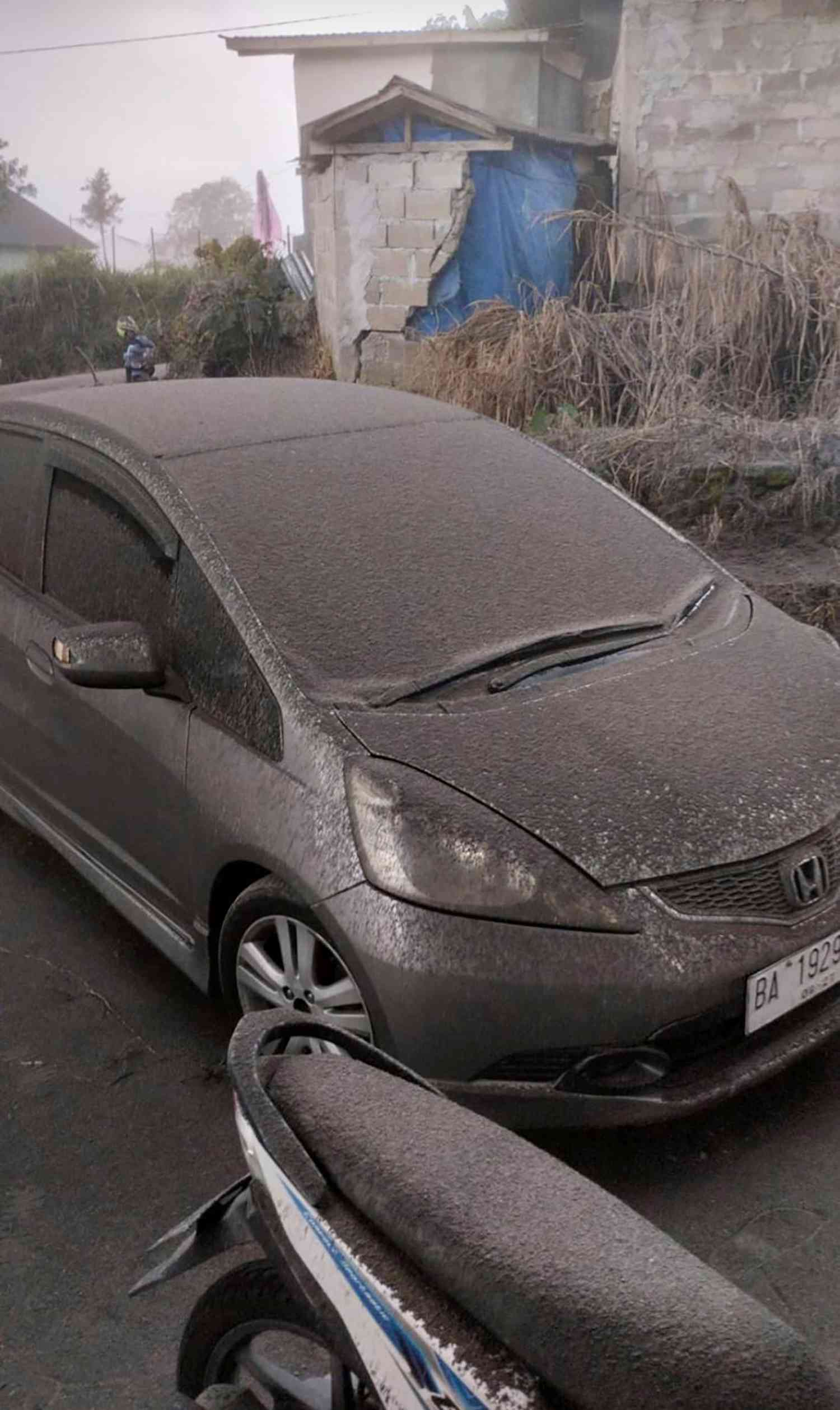 A handout photo made available by the Agam Regional Disaster Management Agency (BPBD) shows vehicles covered with volcanic ashes following the Mount Marapi eruption in Nagari Lasi, Agam, West Sumatra, Indonesia, 03 December 2023