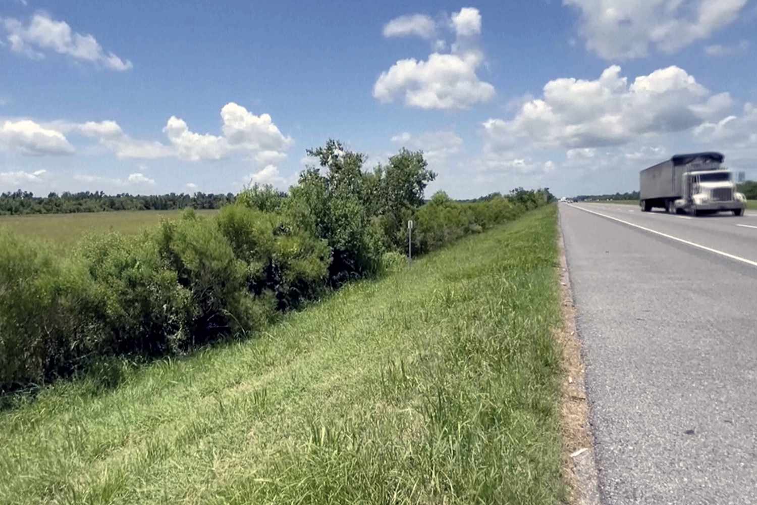 This image made from video provided by KPLC shows a truck passing along the highway where a 1-year-old child was found on Tuesday, July 9, 2024.