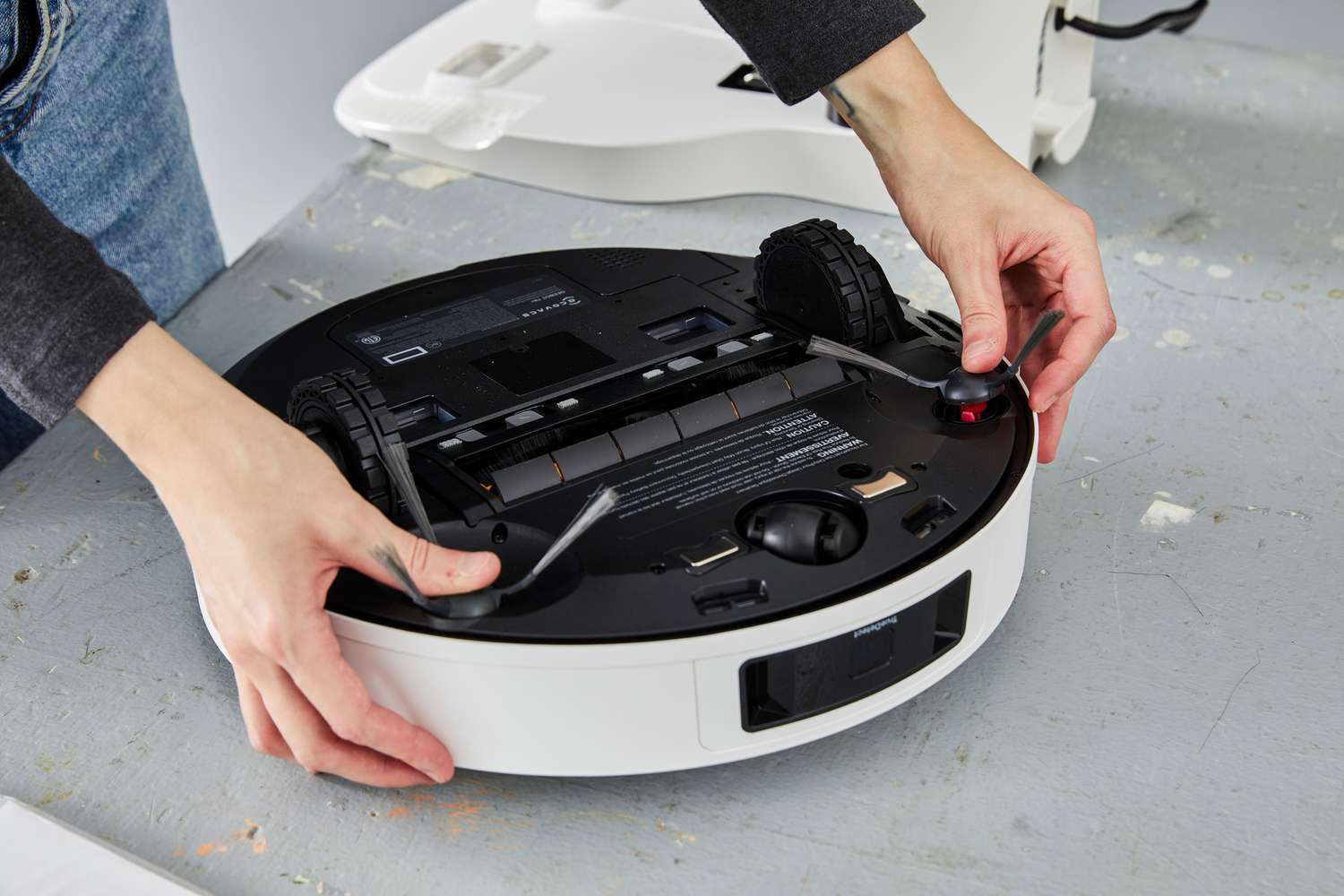 A person adjusts the Ecovacs Deebot T9+ Robot Vacuum and Mop Combo