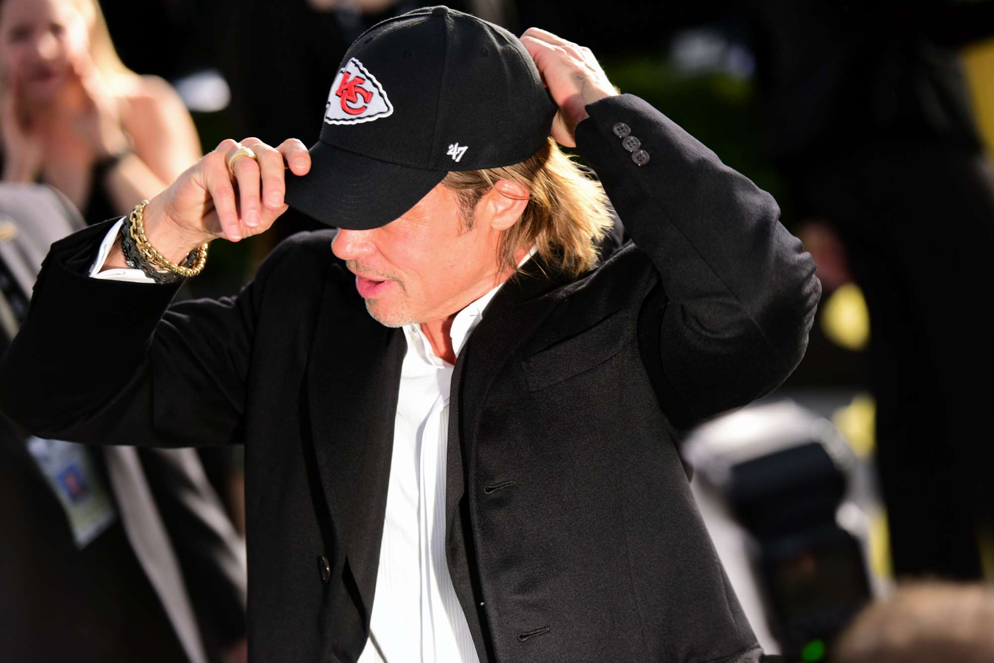 Actor Brad Pitt puts on a Kansas City Chiefs hat at the 26th annual Screen Actors Guild Awards at The Shrine Auditorium on January 19, 2020 in Los Angeles, California.