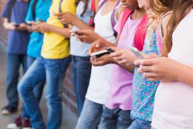 Kids using mobile phone at the elementary school