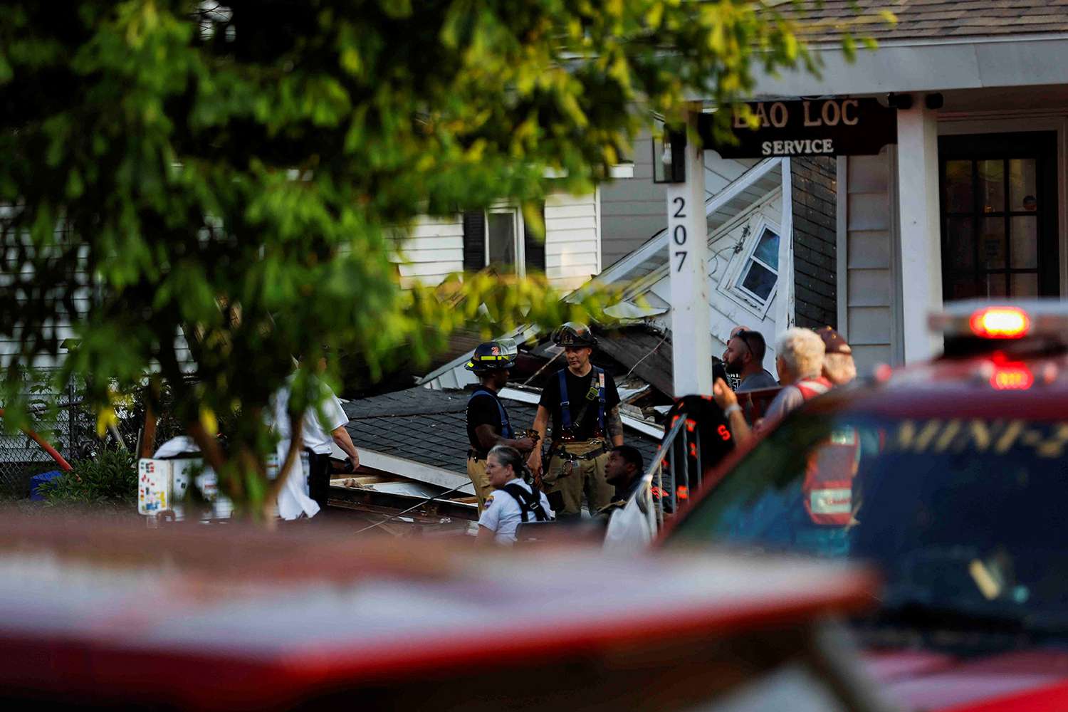 First responders work at the site of a house collapse due to a suspected gas explosion in Syracuse, New York, U.S., June 18, 2024