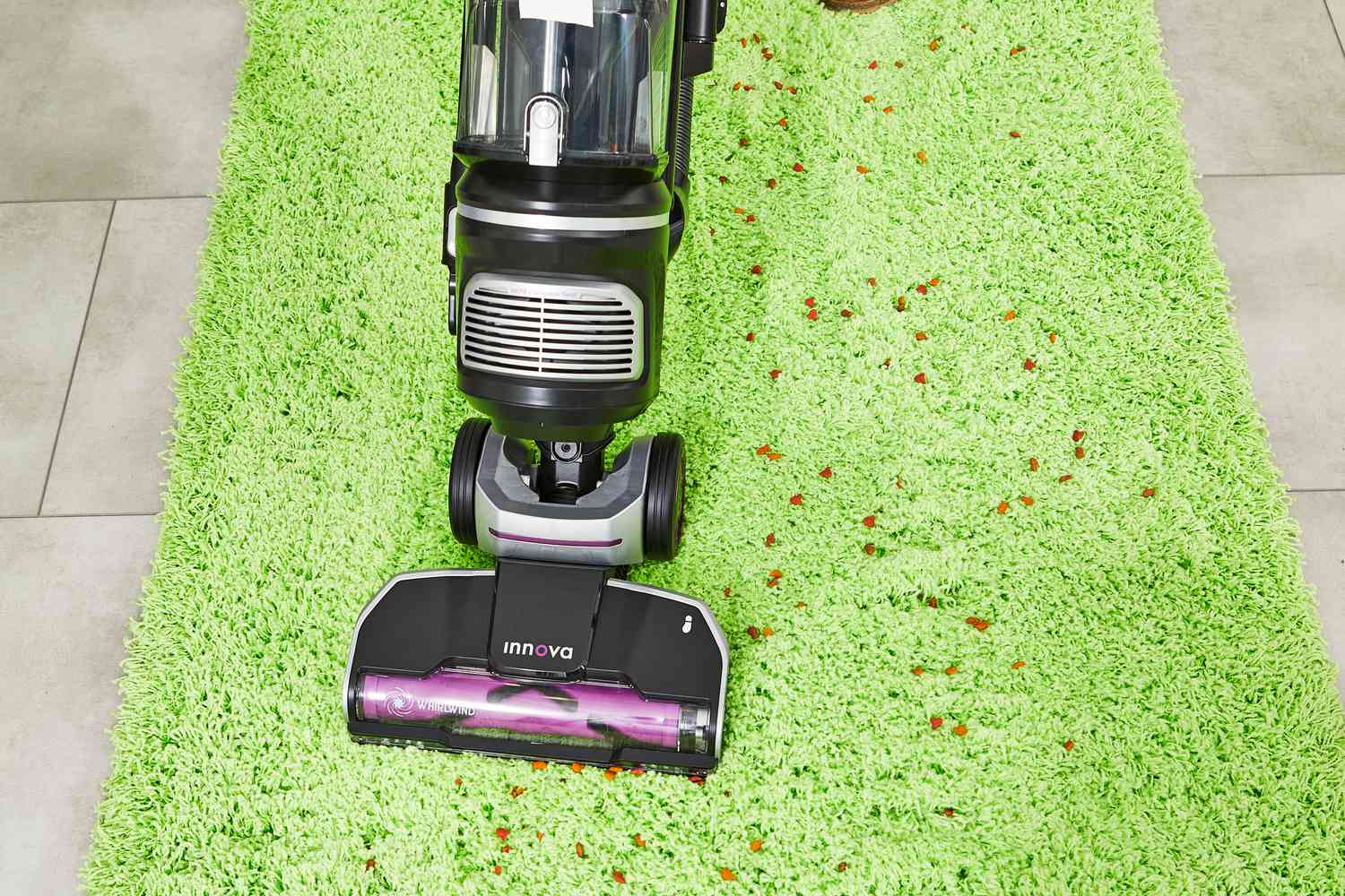 Eureka NEU700 Innova Upright Vacuum used to clean the spill on the green carpet
