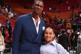 Chris Bosh and Adrienne Williams Bosh on March 18, 2022 at FTX Arena in Miami, Florida.