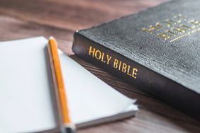 Holy Bible with pencil and paper