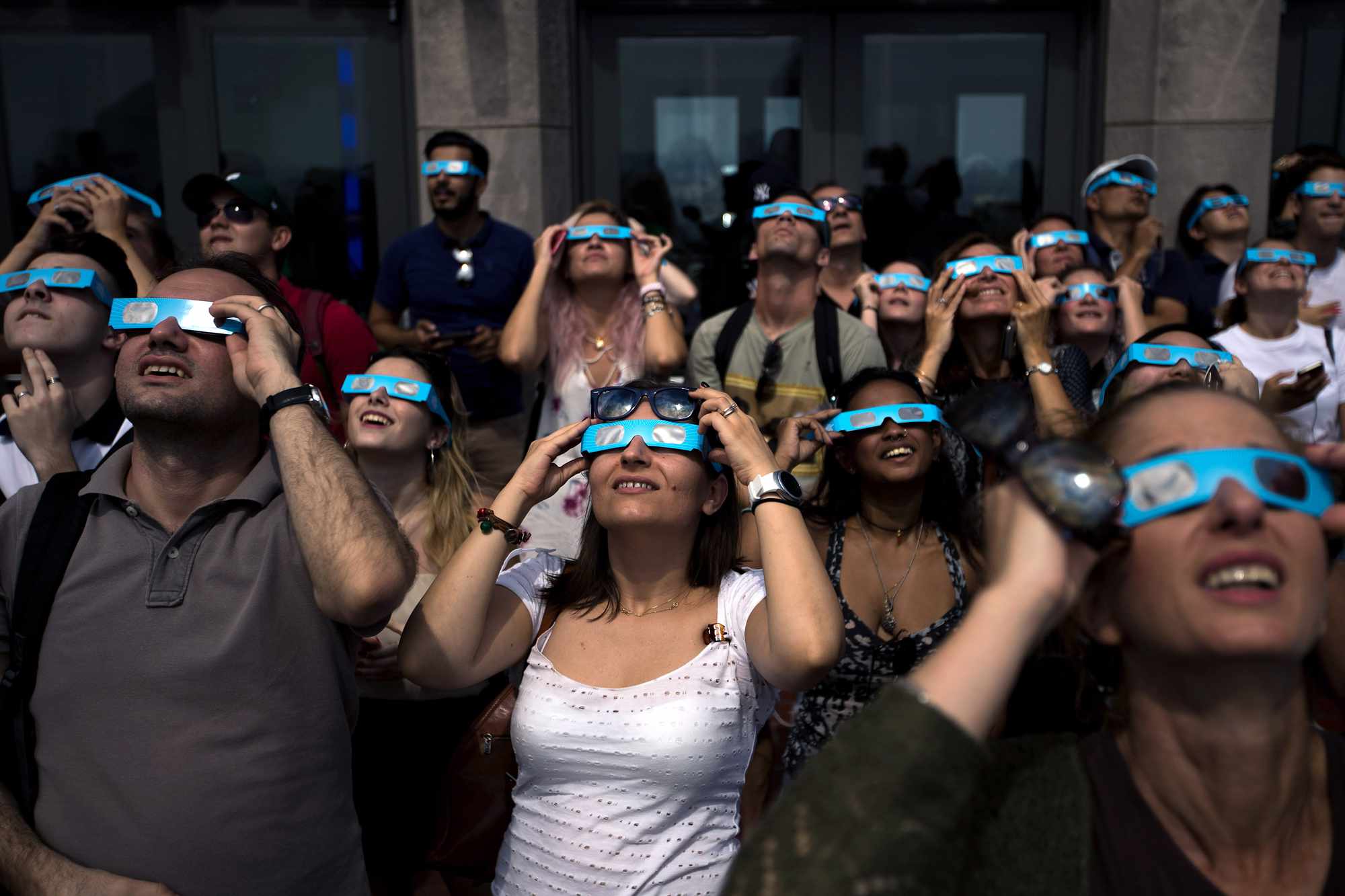 People view the solar eclipse at 'Top of the Rock' observatory at Rockefeller Center, August 21, 2017 in New York City. 